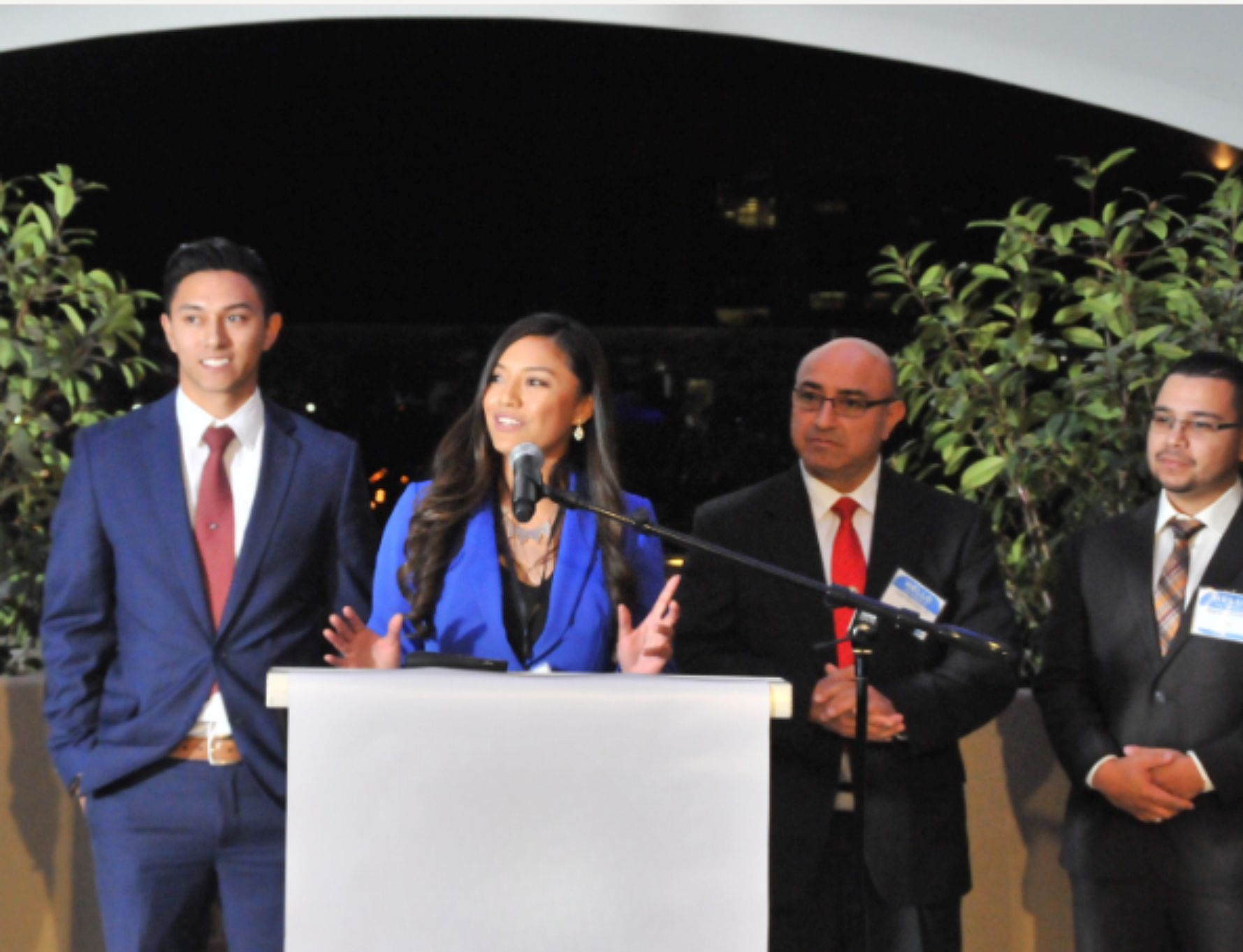 Christen Montero speaking at a podium